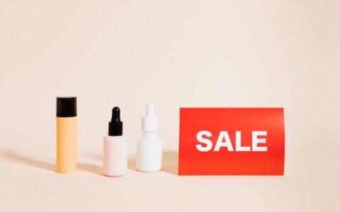 Three skincare bottles with a red sale sign, perfect for shopping promotions.