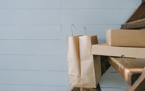 Minimalist image of paper and cardboard packaging on stairs, perfect for e-commerce themes.